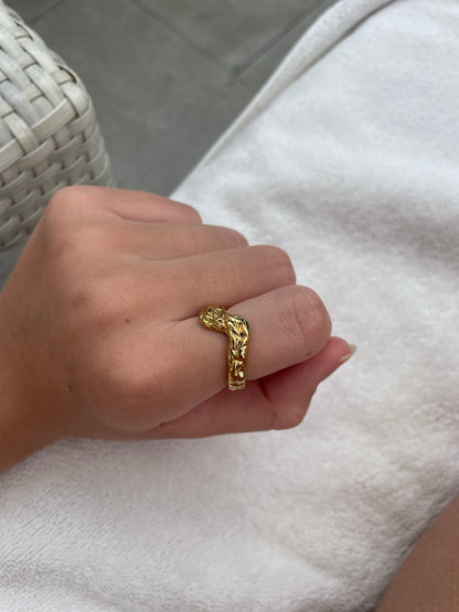 Woman wearing gold-plated hammered V-shape wave ring on hand